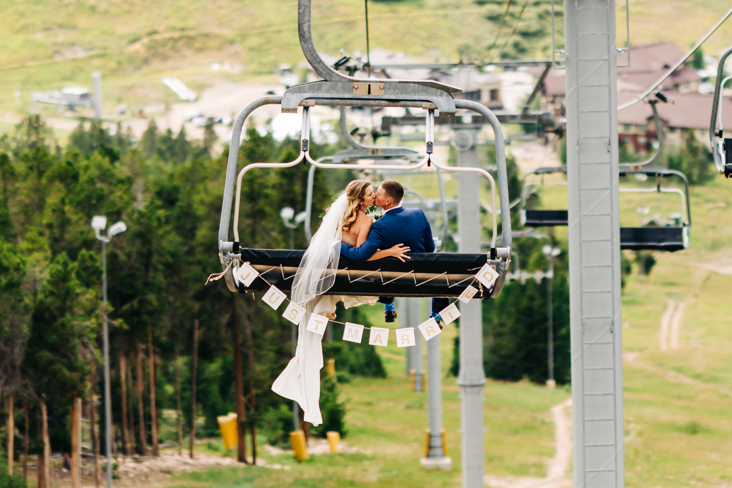 Bride and Groom on chair lift at Granby Ranch. 