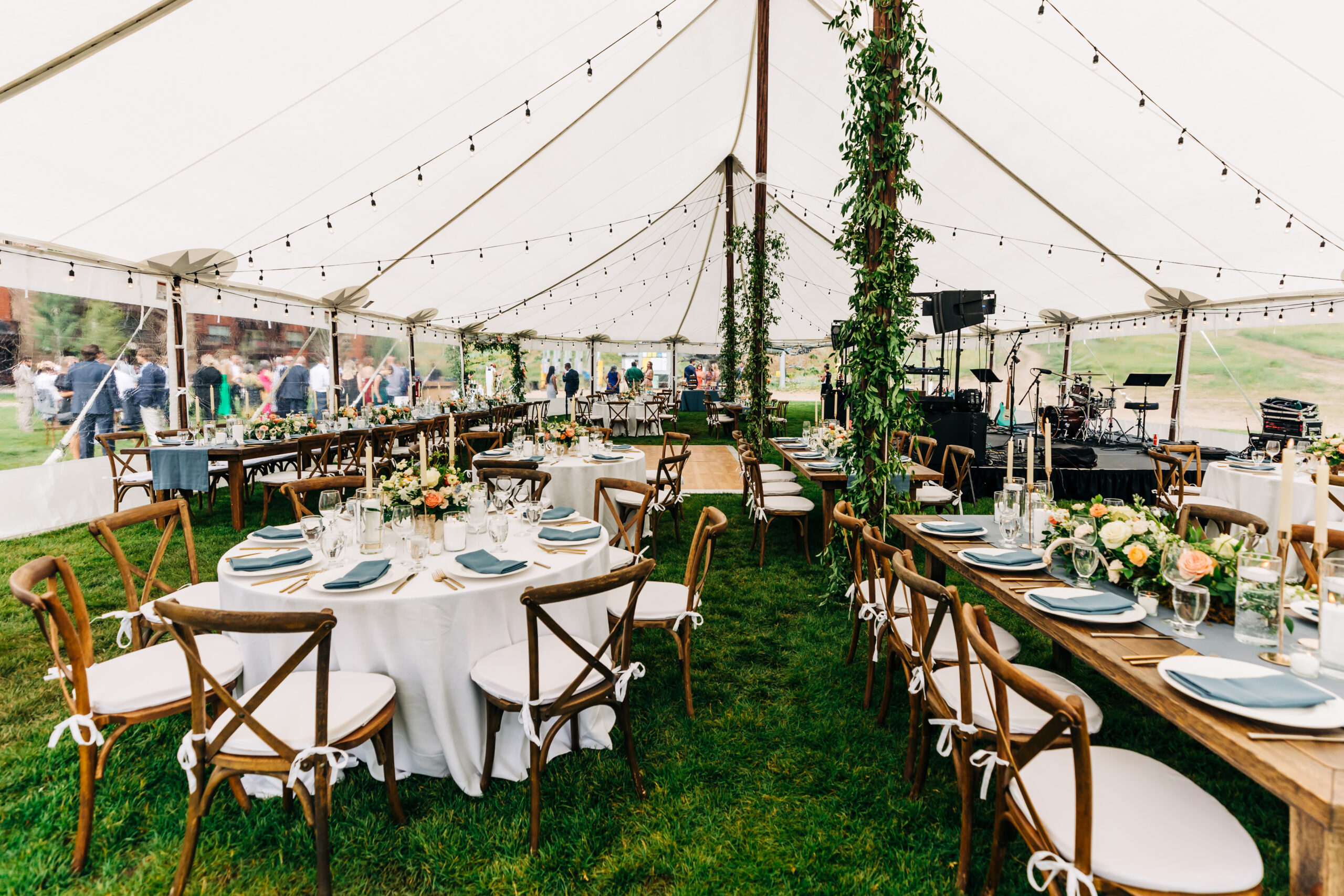 Sailcloth tent with greenery on poles