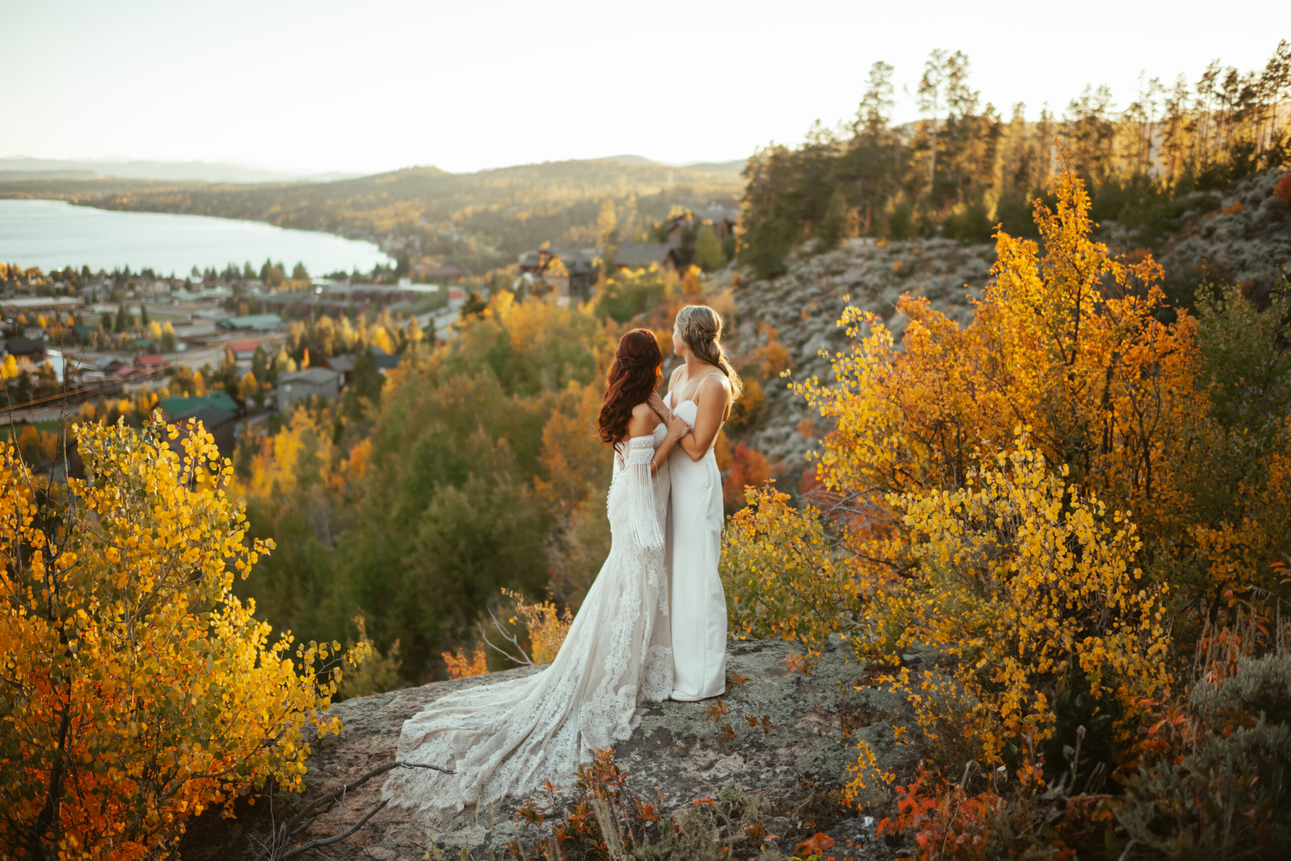 LGBTQ+ couple in fall leaves overlooking Grand Lake