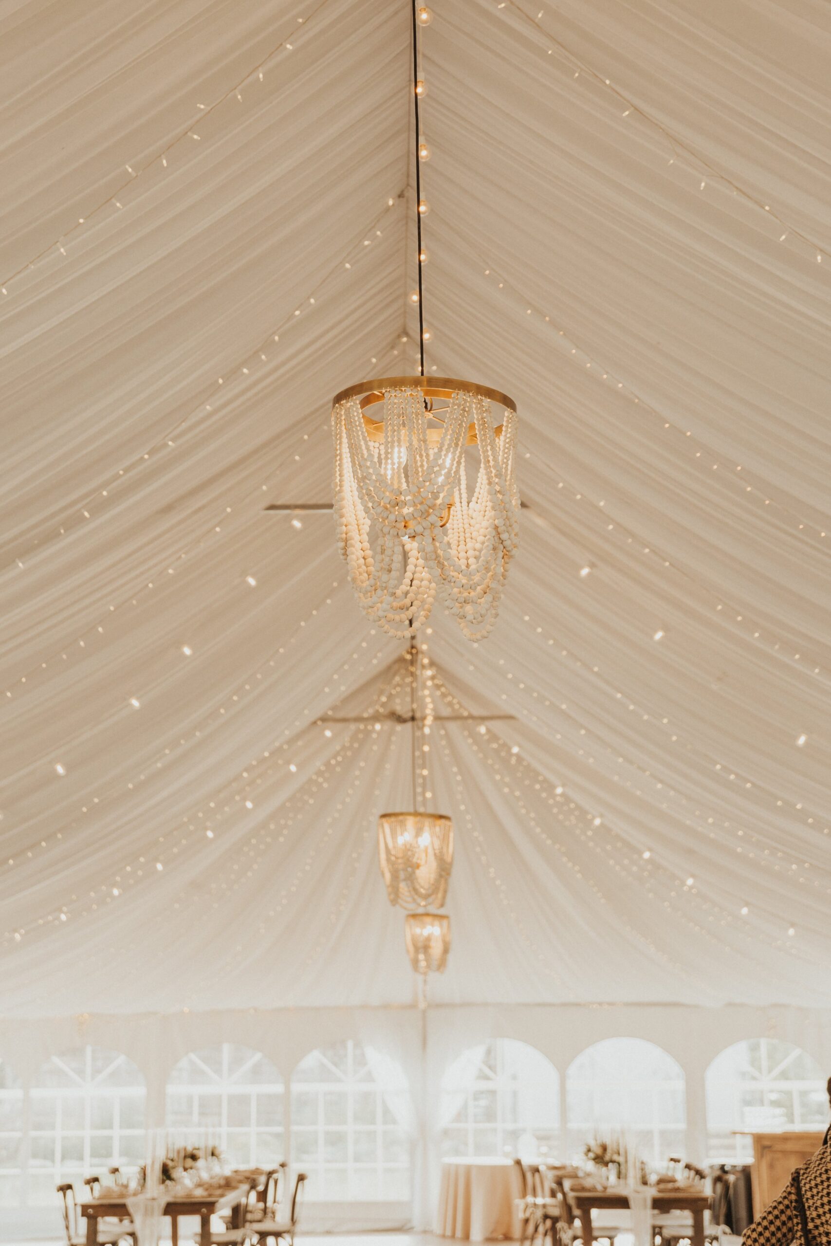 hanging chandeliers inside Camp Hale wedding reception tent