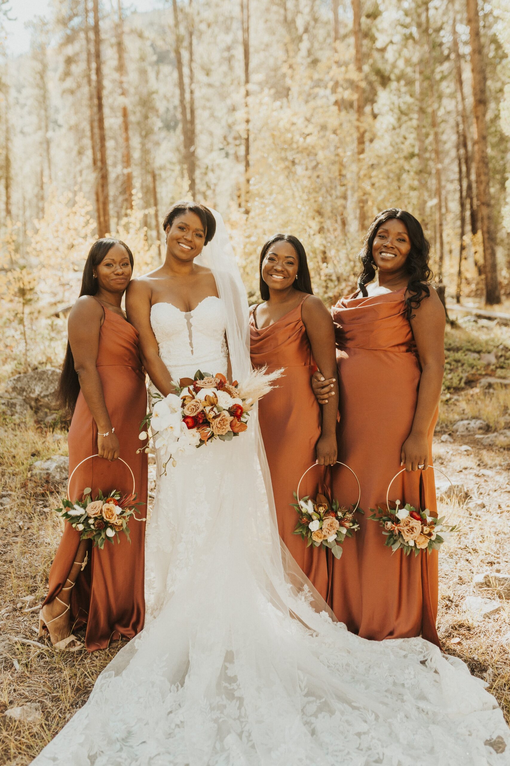 bride with bridesmaids posed at Camp Hale wedding